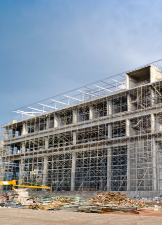 A business building is under construction, protected by a surety bond.  
