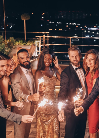 Image of crystal glasses full of champagne held by friends gathered at a one-day event. 