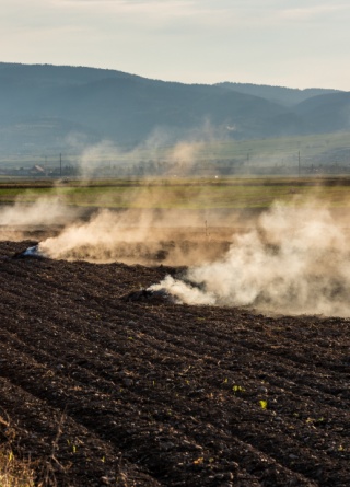 Farmers burn the dry grass and straw stubble on fields in autumn, practicing outdoor burning safety.