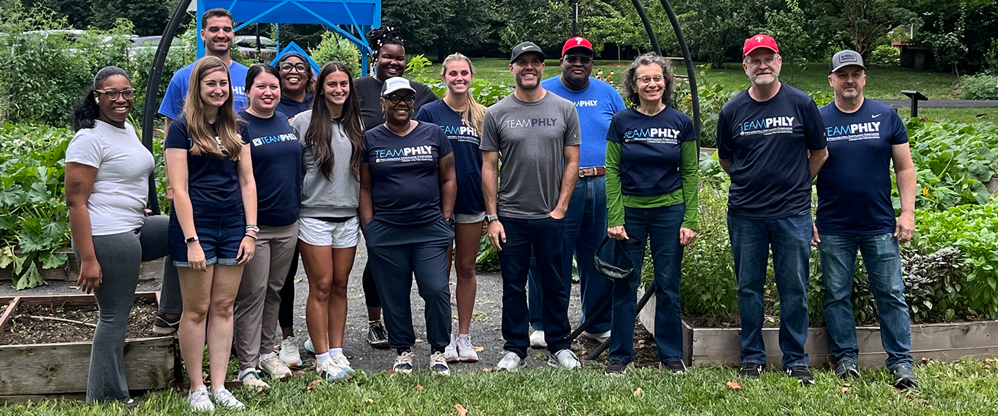 PHLY Employees smiling at the Karabots Garden event.