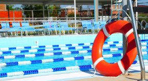 Lifesaving pool ring next to a public swimming pool