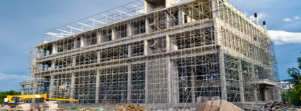 A business building is under construction, protected by a surety bond.  