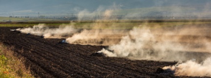 Farmers burn the dry grass and straw stubble on fields in autumn, practicing outdoor burning safety.