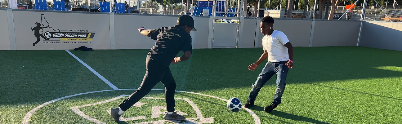 Two children test out the new sneakers they received through PHLY's donation at the LA Galaxy field.