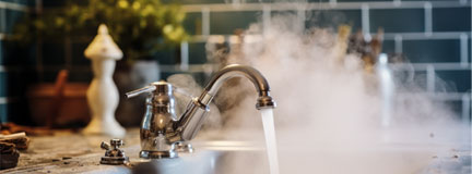 Hot water flowing from a modern faucet with steam rising, signifying hygiene, warmth, and the comforts of a well-equipped home Stock Photo | Adobe Stock 