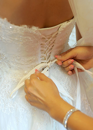 Special Events Banner Wedding Dress Being Tied