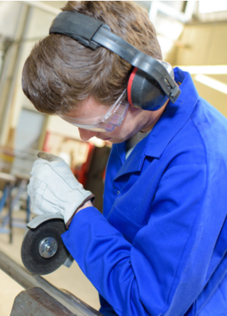 Young man in blue using angle grinder