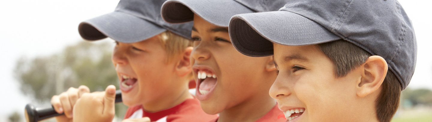 3 young boy baseball players wearing gray hats and red and white jerseys.